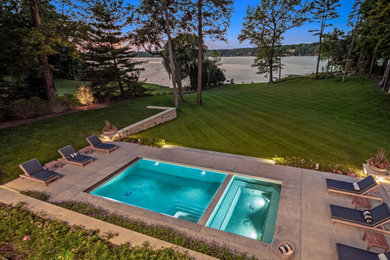 Huge minimalist backyard concrete and rectangular pool landscaping photo in Detroit