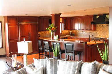 Inspiration for a timeless u-shaped porcelain tile open concept kitchen remodel in Seattle with an island, raised-panel cabinets, medium tone wood cabinets, granite countertops, gray backsplash, ceramic backsplash, stainless steel appliances and an undermount sink