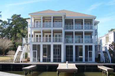 Beach style beige three-story concrete fiberboard townhouse exterior photo in Miami with a shingle roof