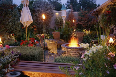 Design ideas for a mid-sized contemporary backyard formal garden in Calgary with brick pavers.