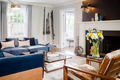 Mid-sized transitional formal and enclosed medium tone wood floor living room photo in New York with gray walls, a standard fireplace, a wood fireplace surround and no tv