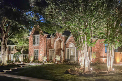 Inspiration for a large transitional shade front yard stone and wood fence landscaping in Dallas for spring.