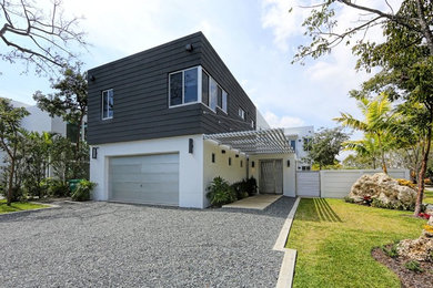 Inspiration for a contemporary black two-story mixed siding exterior home remodel in Miami