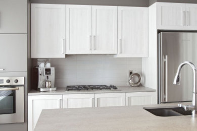 Inspiration for a contemporary kitchen remodel in Edmonton with an undermount sink, shaker cabinets, gray cabinets, gray backsplash, ceramic backsplash and stainless steel appliances