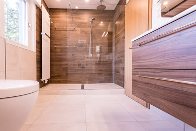 Mittelgroßes Modernes Badezimmer mit dunklen Holzschränken, beigen Fliesen, beiger Wandfarbe, integriertem Waschbecken und weißer Waschtischplatte in Frankfurt am Main