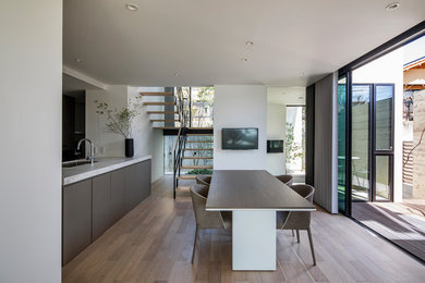 Mid-sized minimalist great room photo in Nagoya with white walls