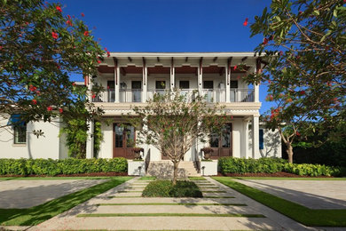 This is an example of a large transitional two-storey stucco white exterior in Miami.