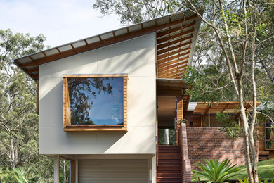 Inspiration for a contemporary white house exterior in Brisbane with a shed roof.