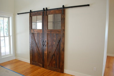 Entryway - mid-sized rustic medium tone wood floor entryway idea in Orlando with white walls and a dark wood front door