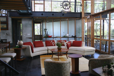 Example of a mid-sized trendy formal and open concept concrete floor and black floor living room design in Tampa with gray walls, no fireplace and no tv