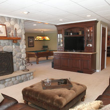 basement rec room with stone fireplace