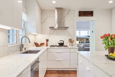 Small minimalist l-shaped medium tone wood floor and brown floor enclosed kitchen photo in Cincinnati with a single-bowl sink, flat-panel cabinets, white cabinets, quartz countertops, white backsplash, quartz backsplash, stainless steel appliances, an island and white countertops