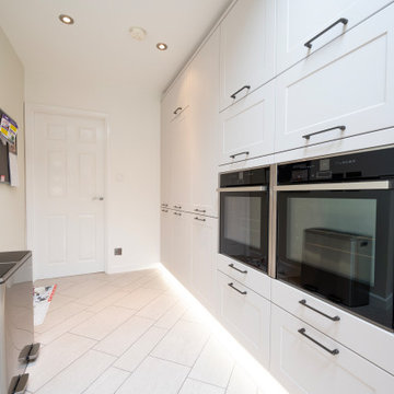 Plinth lighting continues under the bank of appliances