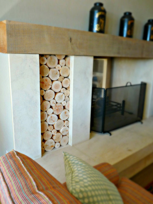 Decorative Logs Stacked in a Fireplace Alcove with Wooden