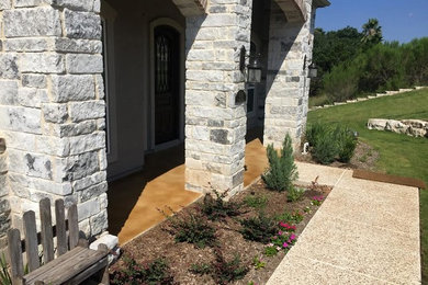 Mid-sized classic concrete paver front porch idea in Austin with a roof extension