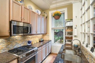 Photo of a small traditional galley separate kitchen in New York with a double-bowl sink.