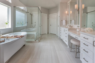 Example of a large minimalist master gray floor and double-sink freestanding bathtub design in Houston with shaker cabinets and white cabinets