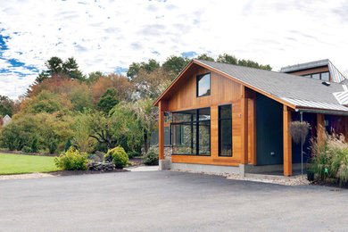 Mid-sized trendy green two-story mixed siding exterior home photo in Boston with a mixed material roof