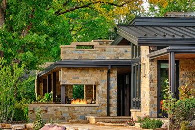 Patio - large contemporary backyard patio idea in Denver with a fireplace and a roof extension