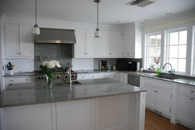 Inspiration for a large transitional l-shaped light wood floor kitchen remodel in Providence with an undermount sink, white cabinets, granite countertops, stainless steel appliances, an island and shaker cabinets