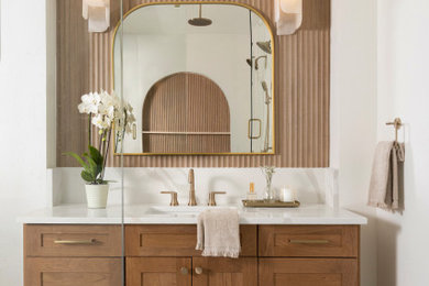Example of a huge transitional brown tile and porcelain tile marble floor, multicolored floor and single-sink bathroom design in Dallas with shaker cabinets, medium tone wood cabinets, a one-piece toilet, white walls, an undermount sink, quartz countertops, a hinged shower door, white countertops and a freestanding vanity