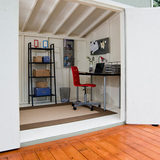 Photo of a medium sized modern home office and library in Detroit.