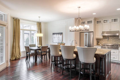 Large trendy l-shaped dark wood floor and brown floor kitchen photo in Other with an undermount sink, raised-panel cabinets, white cabinets, granite countertops, multicolored backsplash, mosaic tile backsplash, stainless steel appliances, an island and beige countertops