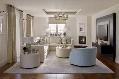 Photo of a large contemporary living room in London with beige walls, a built-in media unit and feature lighting.