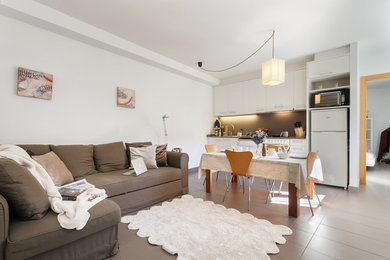Inspiration for a mid-sized transitional open concept ceramic tile living room remodel in Barcelona with white walls