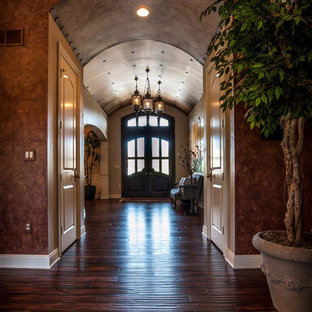 Photo of a large eclectic entry hall in Cleveland with metallic walls, dark hardwood floors, a double front door and a dark wood front door.