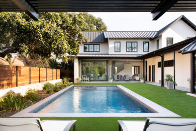Pool - mid-sized backyard stone and rectangular pool idea in Austin