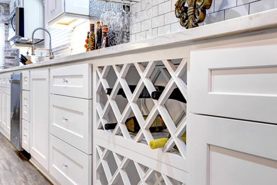 Mid-sized transitional galley porcelain tile and gray floor eat-in kitchen photo in Houston with a double-bowl sink, shaker cabinets, white cabinets, marble countertops, white backsplash, subway tile backsplash, stainless steel appliances and no island