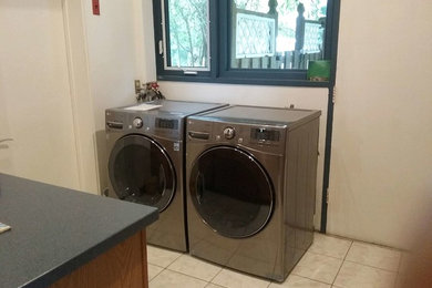 Example of a mid-sized classic l-shaped eat-in kitchen design in DC Metro with beaded inset cabinets, light wood cabinets, solid surface countertops, an island and blue countertops