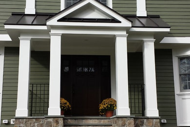 Example of a mid-sized arts and crafts green two-story concrete fiberboard exterior home design in New York