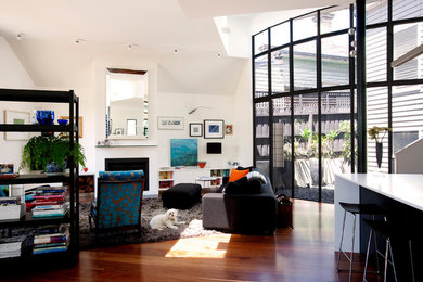 Design ideas for a contemporary open concept living room in Melbourne with white walls and a standard fireplace.