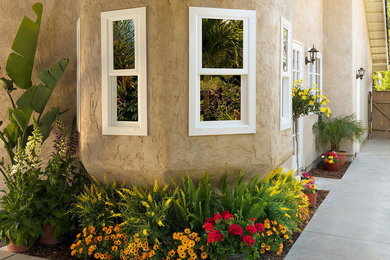 Large elegant beige two-story stucco exterior home photo in San Diego