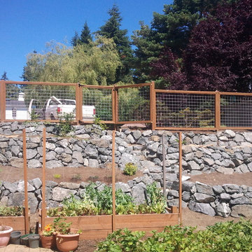 Terraced rock walls and hog wire fence