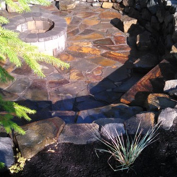 Rustic Outdoor Entertainment  area with fire pit and stone seating