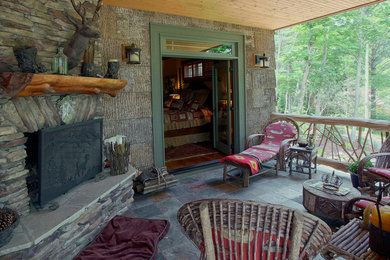 Patio - huge craftsman side yard stone patio idea in Charlotte with a fire pit and a roof extension