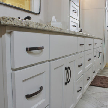 Custom white cabinetry, granite countertops, and generous storage complete this