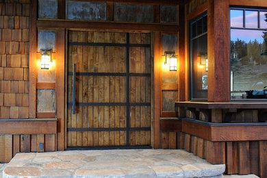 Design ideas for a mid-sized country front door in Charlotte with brown walls, a pivot front door and a medium wood front door.