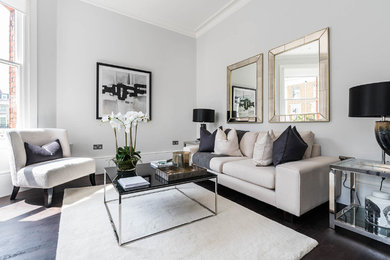 Transitional open concept dark wood floor living room photo in London with gray walls, no fireplace and no tv