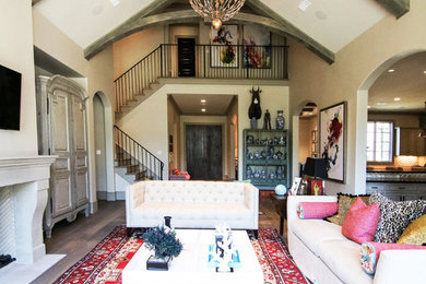 Large trendy formal and enclosed light wood floor and brown floor living room photo in Houston with gray walls, a standard fireplace, a wall-mounted tv and a stone fireplace