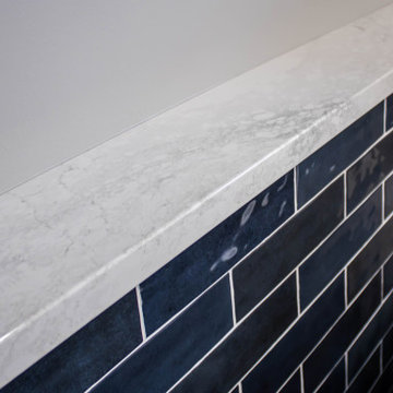 Primary Bathroom with Blue-Gray Vanity and Deep Blue Tiled Feature Wall