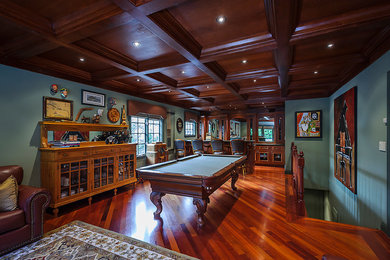 Large traditional loft-style family room in San Francisco with a game room, dark hardwood floors and blue walls.