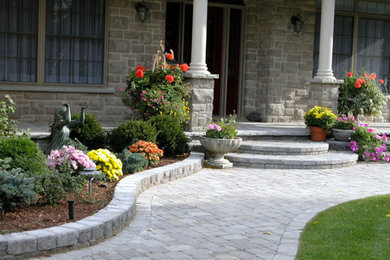 Design ideas for a mid-sized traditional front yard driveway in Toronto.