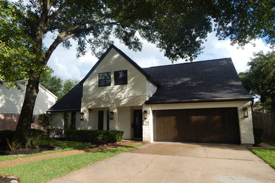 Example of a mid-sized transitional multicolored two-story mixed siding exterior home design in Houston with a shingle roof