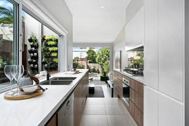 Inspiration for a contemporary galley kitchen pantry in Sydney with a double-bowl sink, white cabinets, ceramic floors, no island and beige floor.