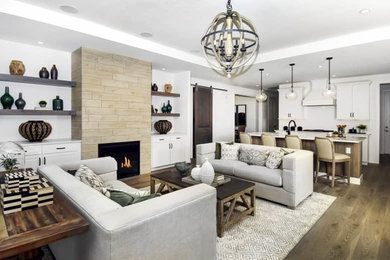 Family room - transitional open concept light wood floor and brown floor family room idea in Denver with white walls, a standard fireplace, a tile fireplace and a media wall