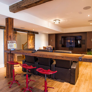 Design ideas for a medium sized country look-out basement in Toronto with beige walls, light hardwood flooring, no fireplace and brown floors.